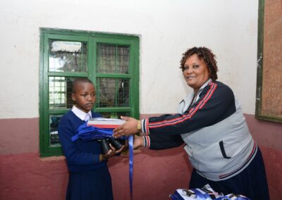 Delivery a gist to one of the pupils in Lyasomboro Primary School
