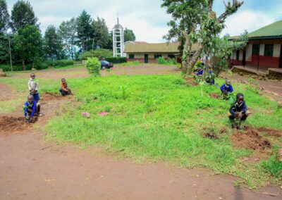 Rose Rise Personnel Offering Scholastic Materials and Tree Seedlings for an Afforestation Project in Schools 13